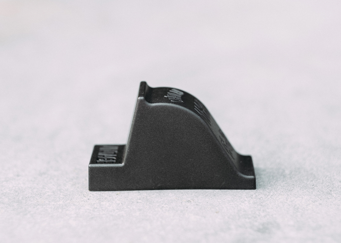 Close-up side view of OAKENZ black planter feet