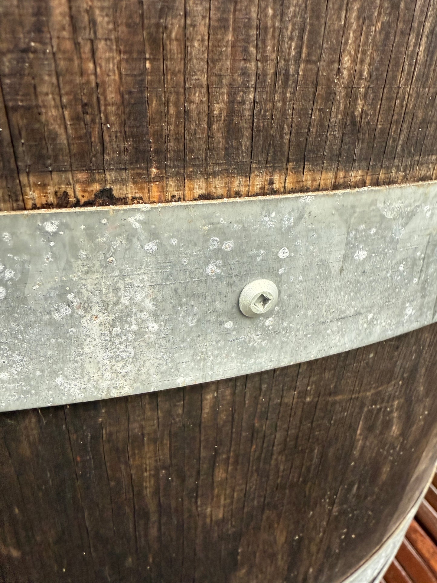 OAKENZ Barrel screws securing the metal hoop on a wine barrel planter