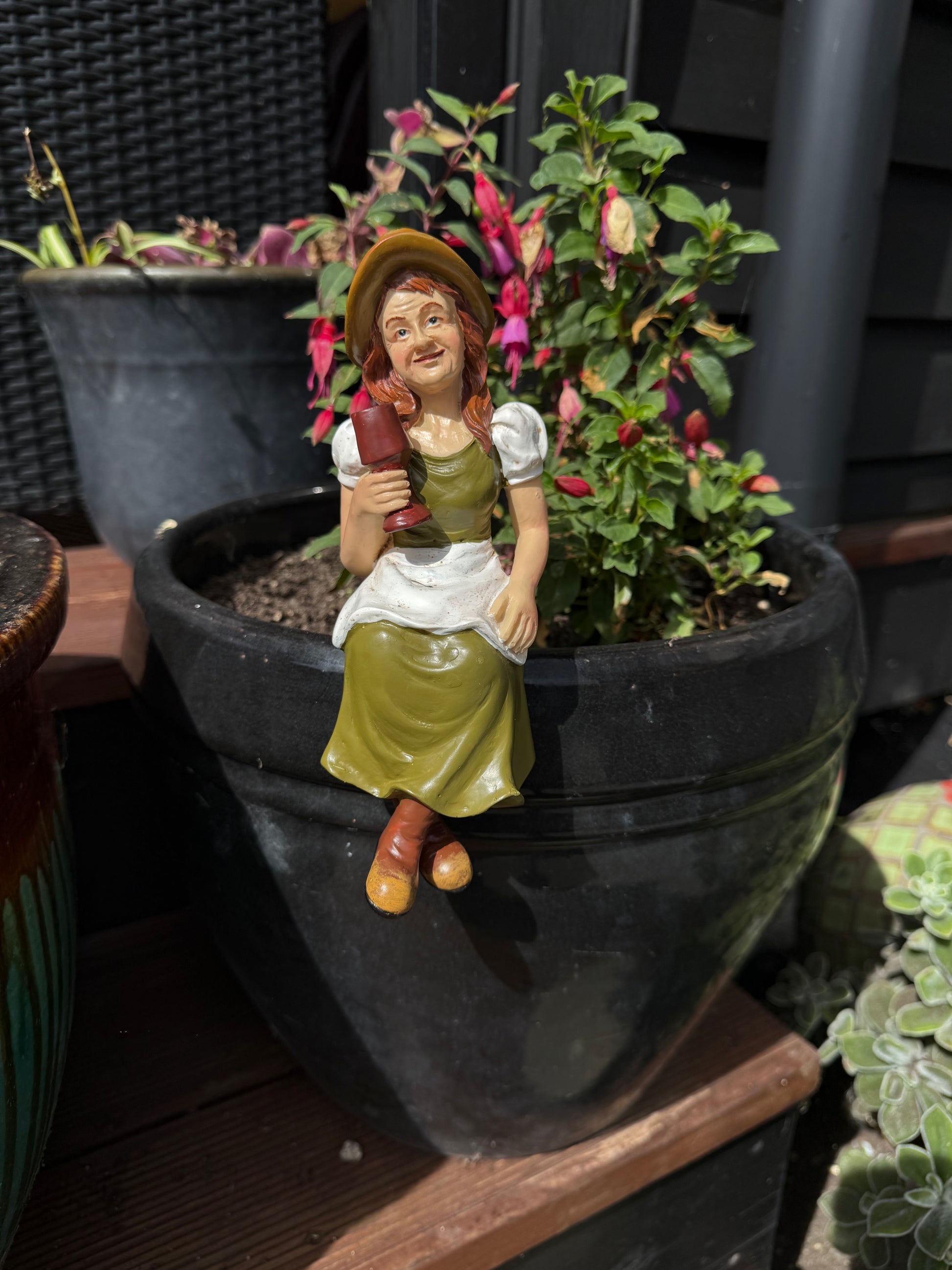 Hand-crafted garden figurine adding character to outdoor pot