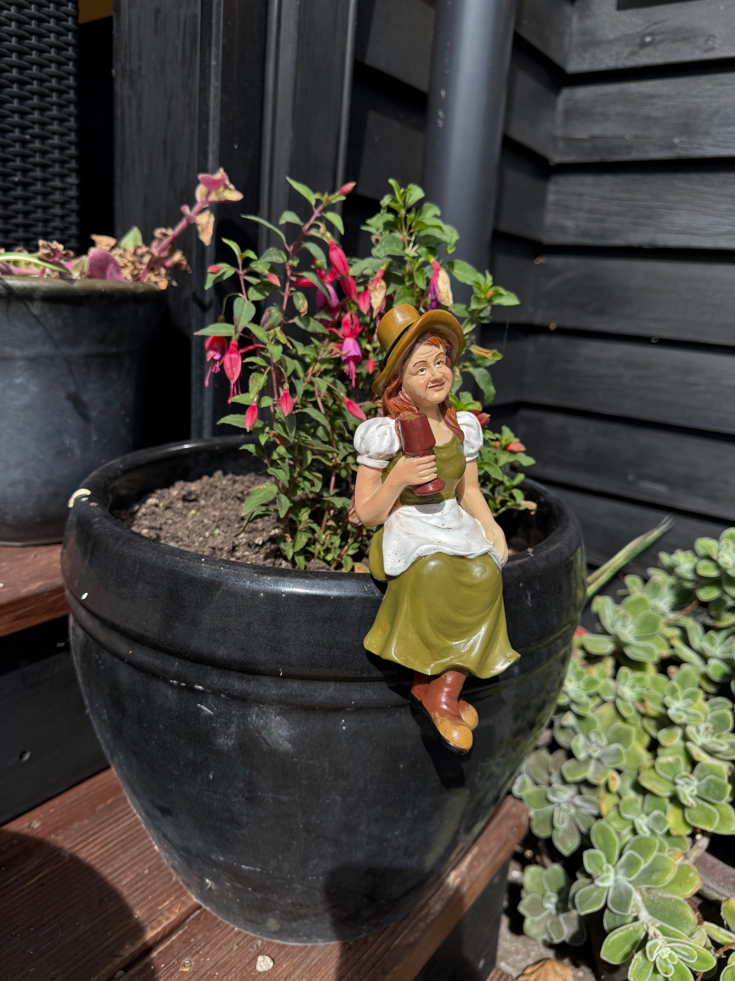 Decorative garden art female figurine sitting on pot